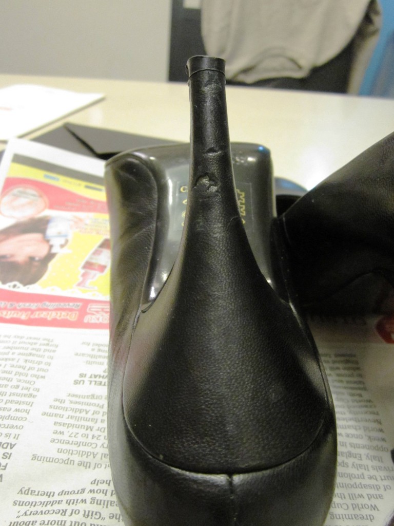This was the more damaged shoe  - you can see how the leather has almost been scraped off the heel. This was after trying to push the leather flap down with a damp cloth